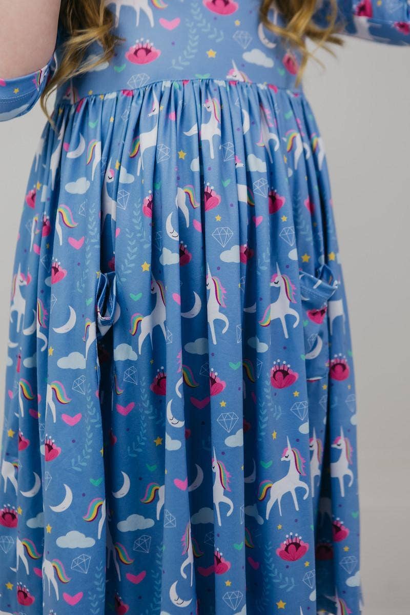 Blue dress with unicorn pattern worn by a girl
