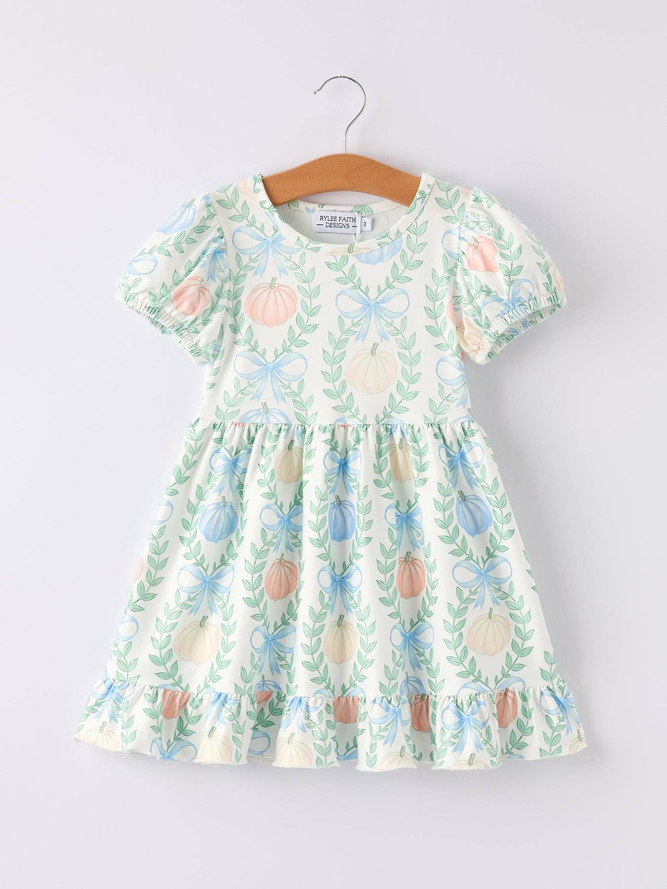pastel pumpkin and bow dress on white background
