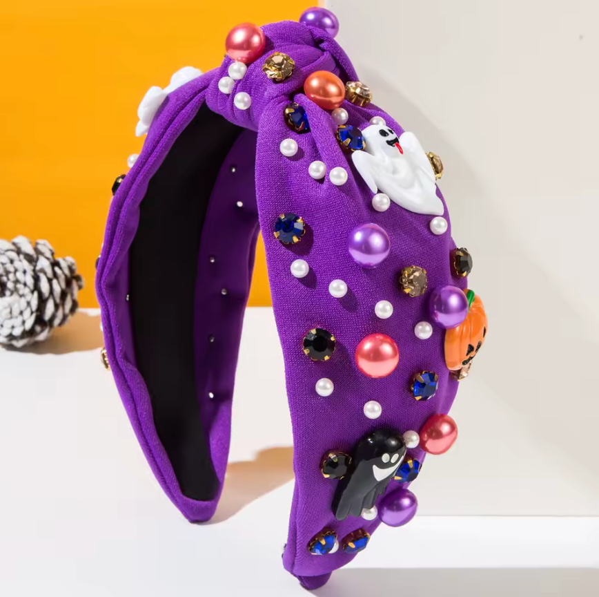 Purple headband with Halloween-themed decorations on a white background