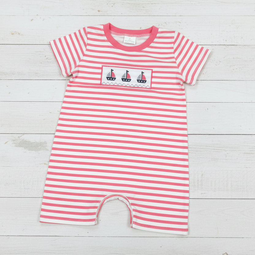 Red and white striped baby romper with sailboat design on a light gray background